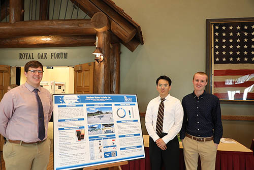 Matthew Isherwood, senior nursing major, and J.D. Kennedy, junior conservation and wildlife management major, explain their research project to Dr. Mark Nowack, professor of engineering and director of the engineering department.